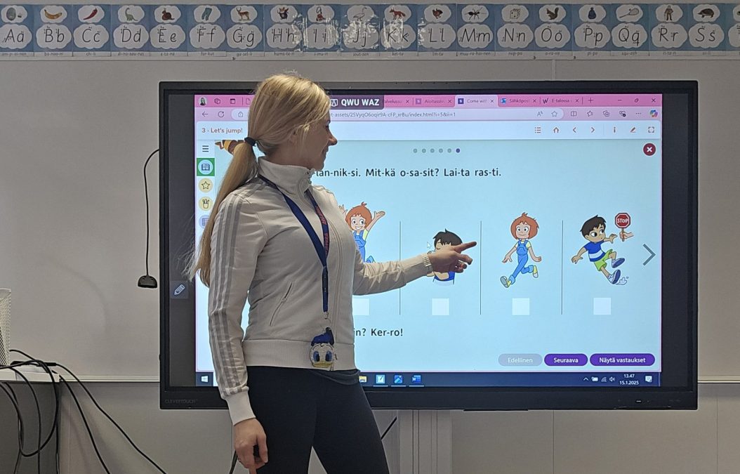 Opettaja älytaulun äärellä